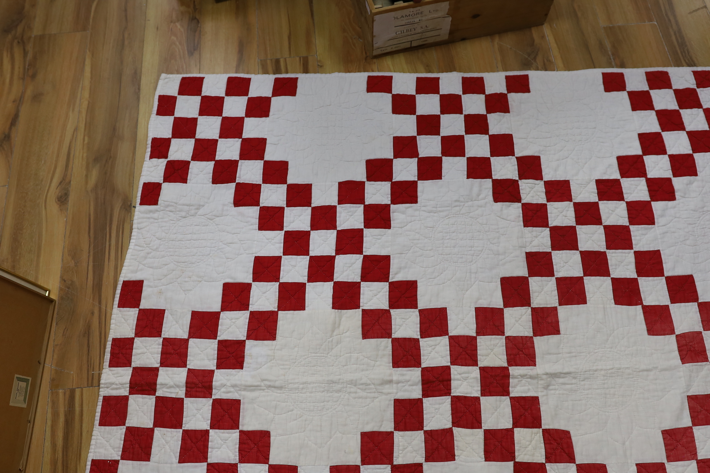 An American quilt Texas Star pattern, red on white backing